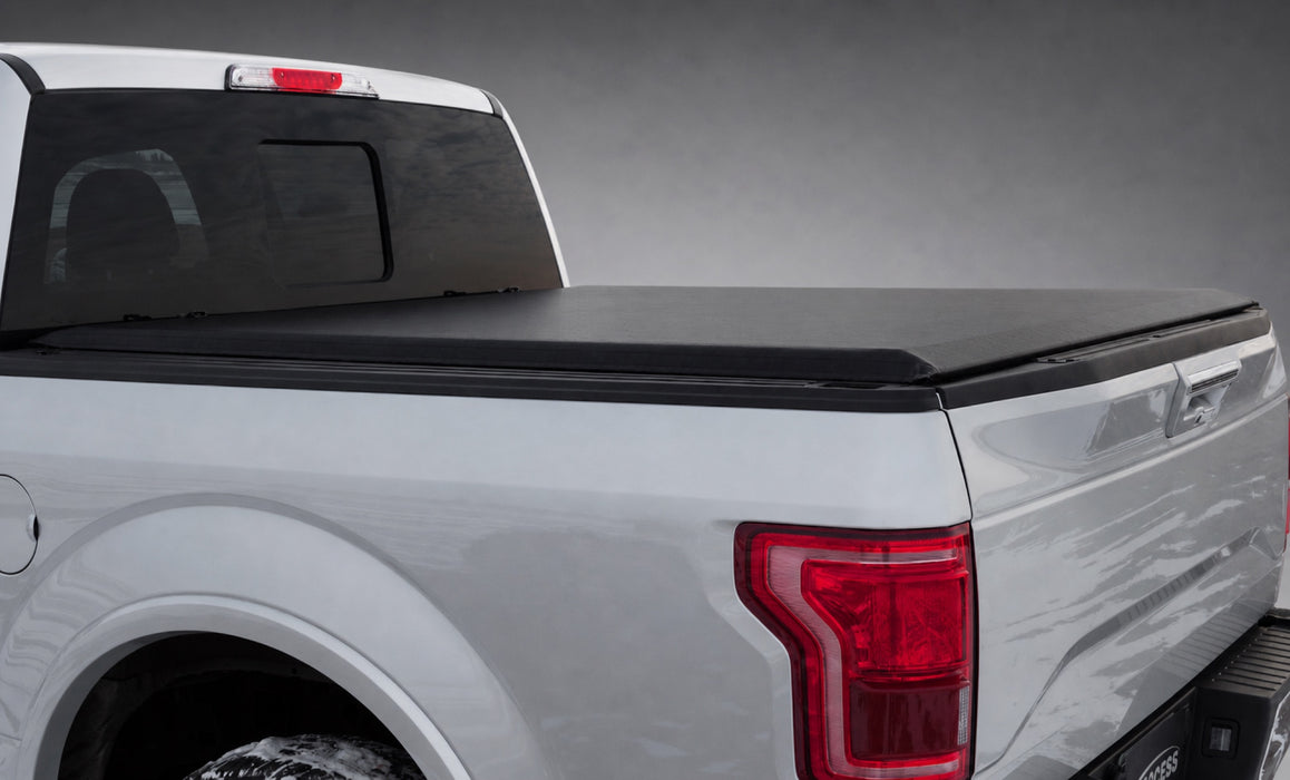 Access Limited soft roll-up tonneau cover on a silver Ford F-150 in a dark gray showroom