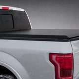 Access Limited soft roll-up tonneau cover on a silver Ford F-150 in a dark gray showroom