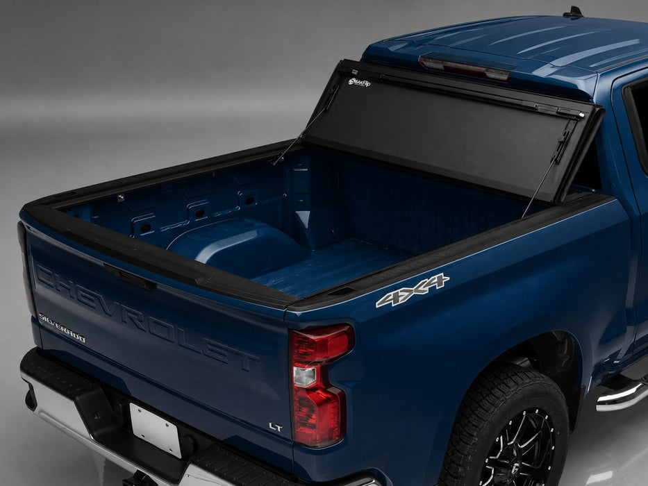 BAKFlip MX4 tonneau cover on 2019-2027 Chevy/GMC Silverado/Sierra 1500 5'8" bed, rear three-quarter detail, cover open